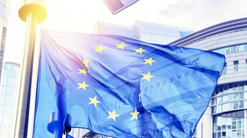 EU flags waving in front of European Parliament building. Brussels, Belgium